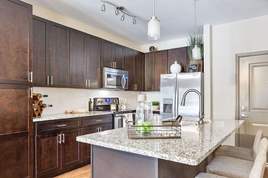 a kitchen with wooden cabinets and a granite counter top