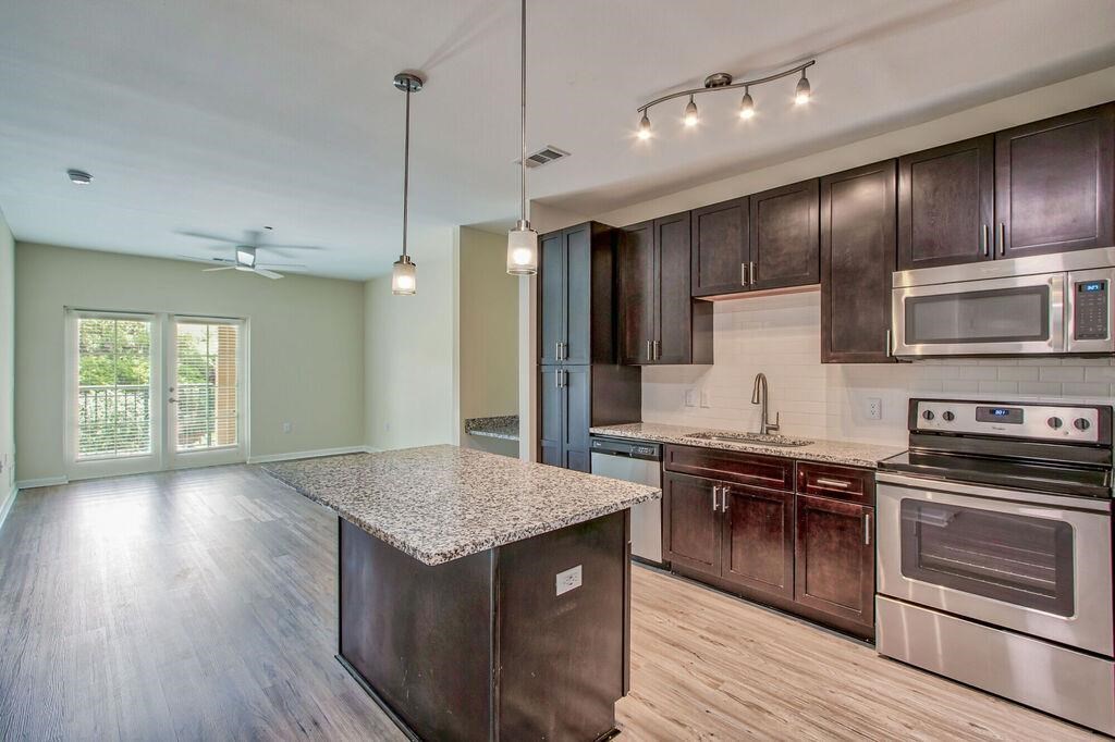 a kitchen with stainless steel appliances and a marble counter top