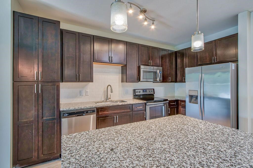 a kitchen with stainless steel appliances and wooden cabinets
