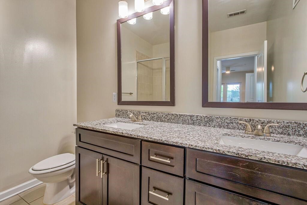 a bathroom with two sinks and a toilet