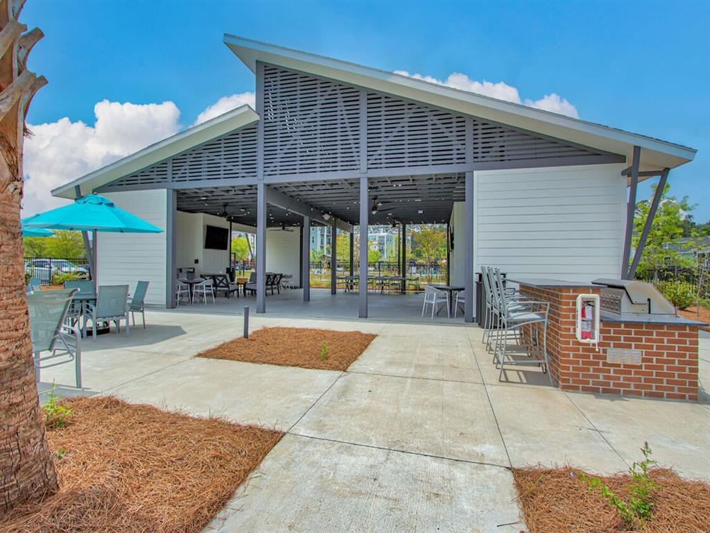a patio with tables and chairs and a pavilion