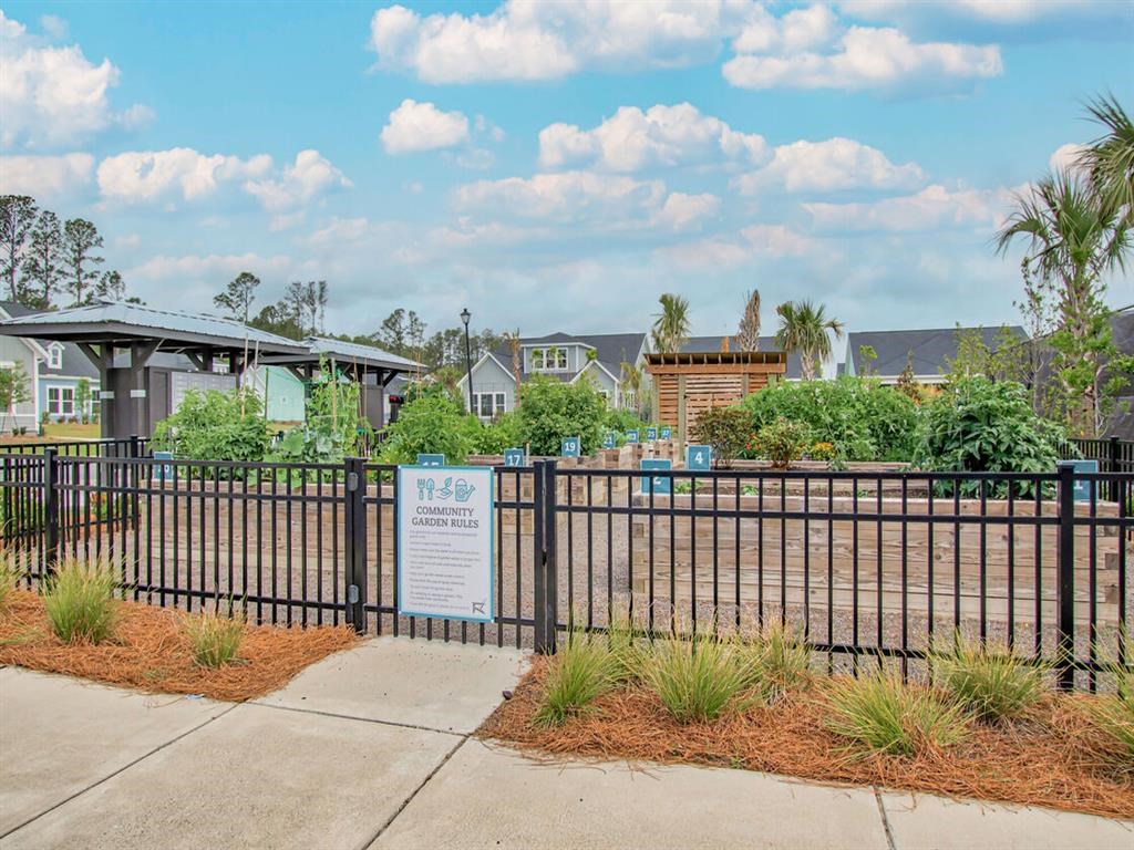 a wrought iron fence with a pool in front of some houses