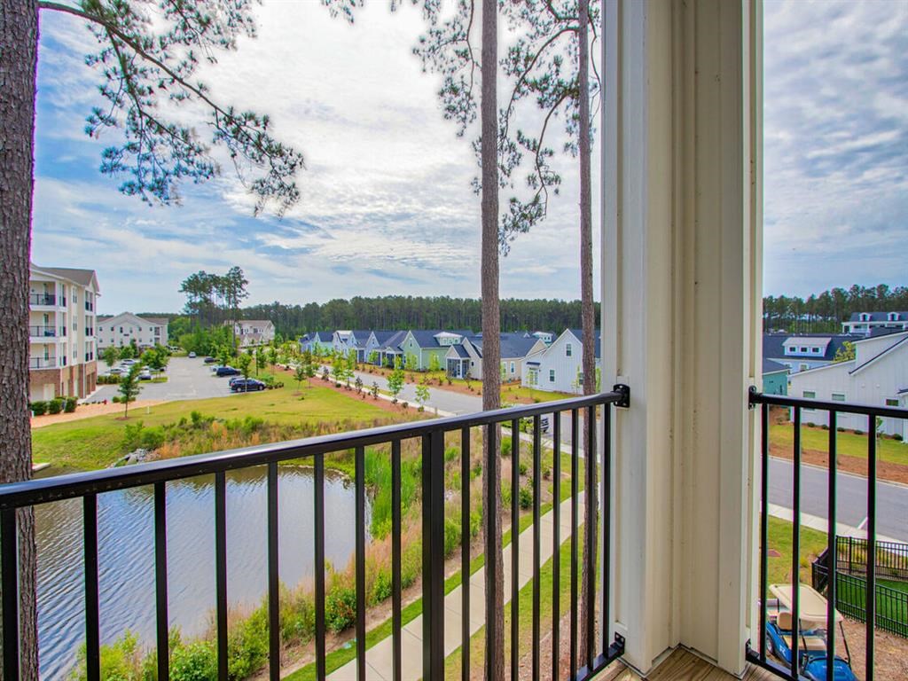 a balcony with a view of a lake and some houses
