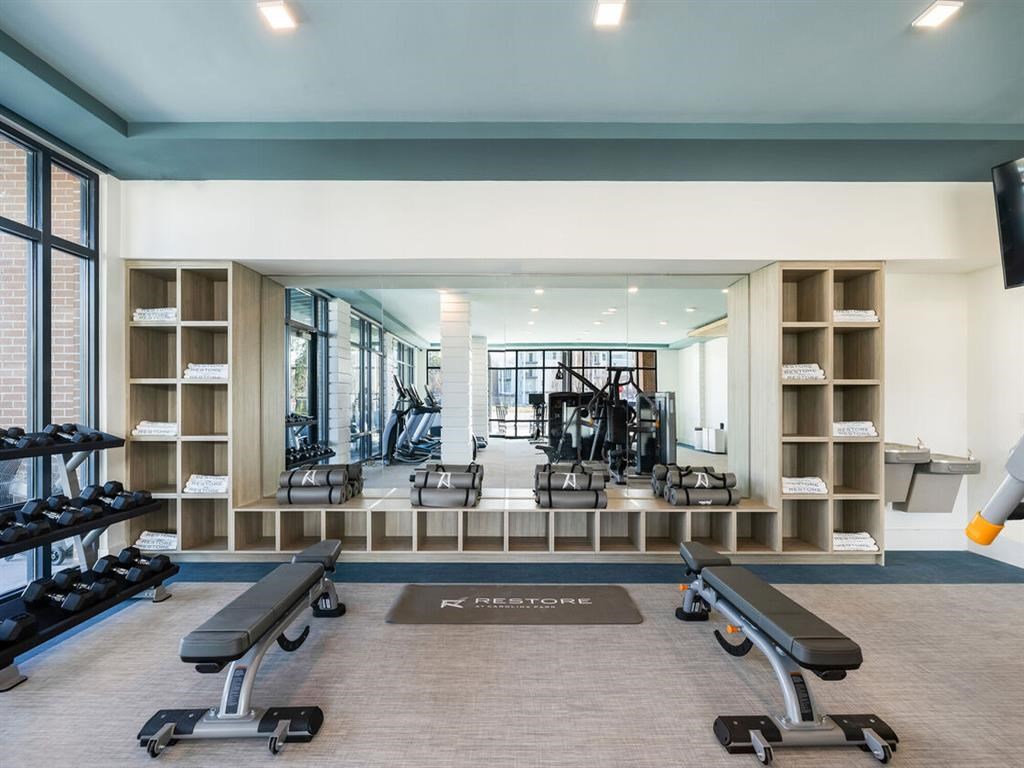 a gym with weights and other exercise equipment in a large room