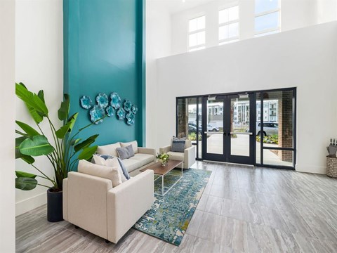 a living room with a blue wall and white furniture