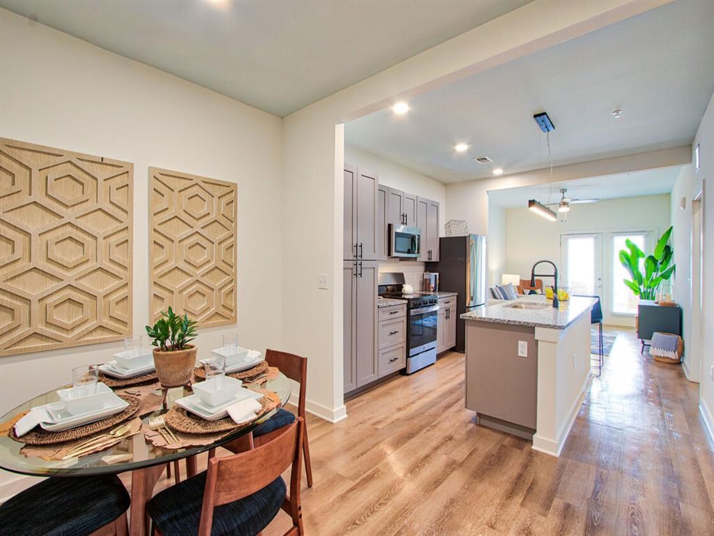 a kitchen and dining room with a table and chairs