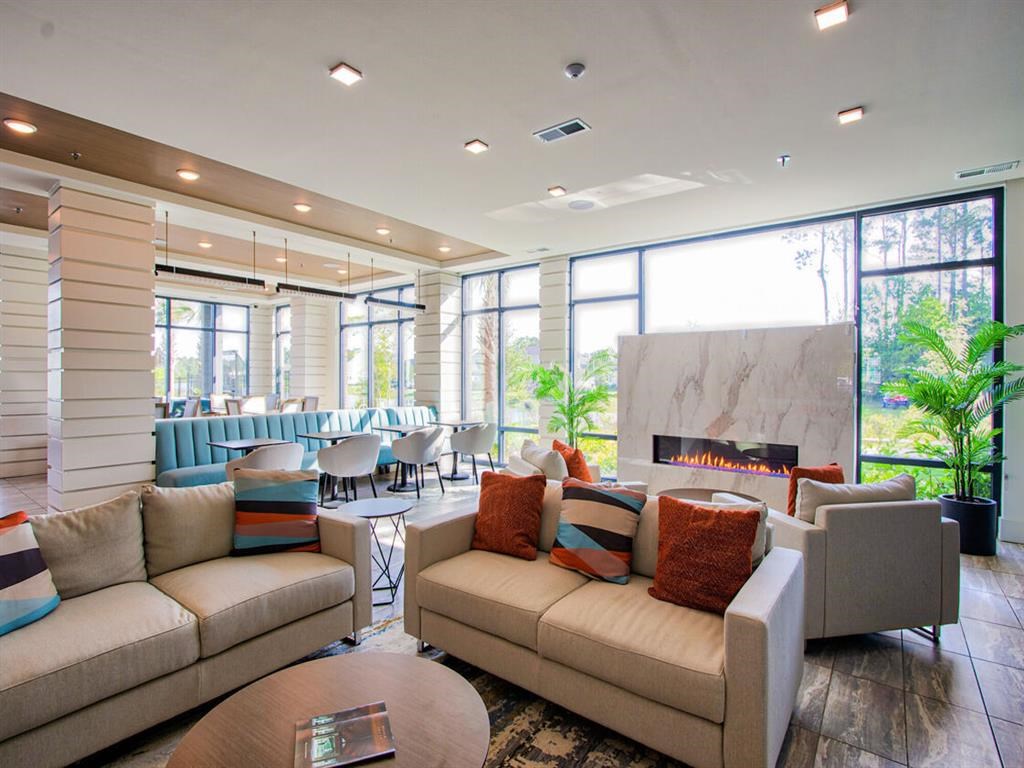 a living room with couches and a table and a fireplace