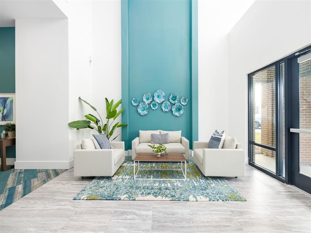 a living room with a blue wall and white furniture