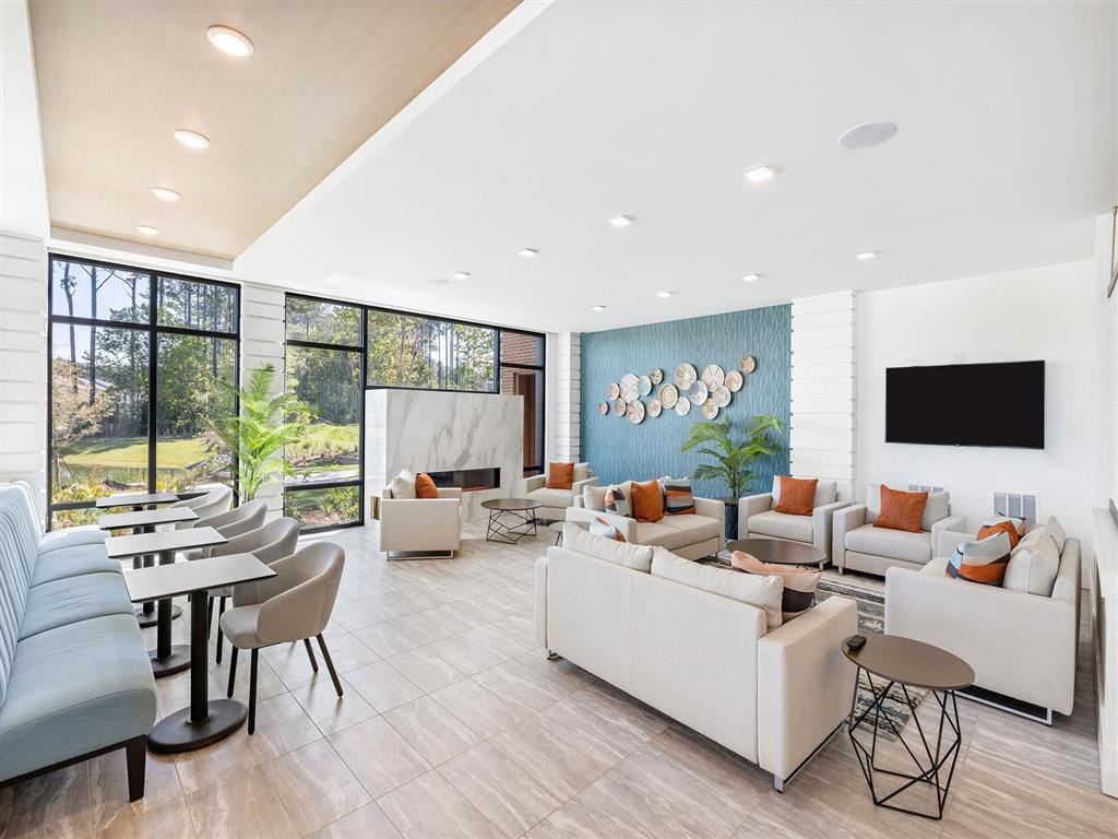 a living room with couches and chairs and a television