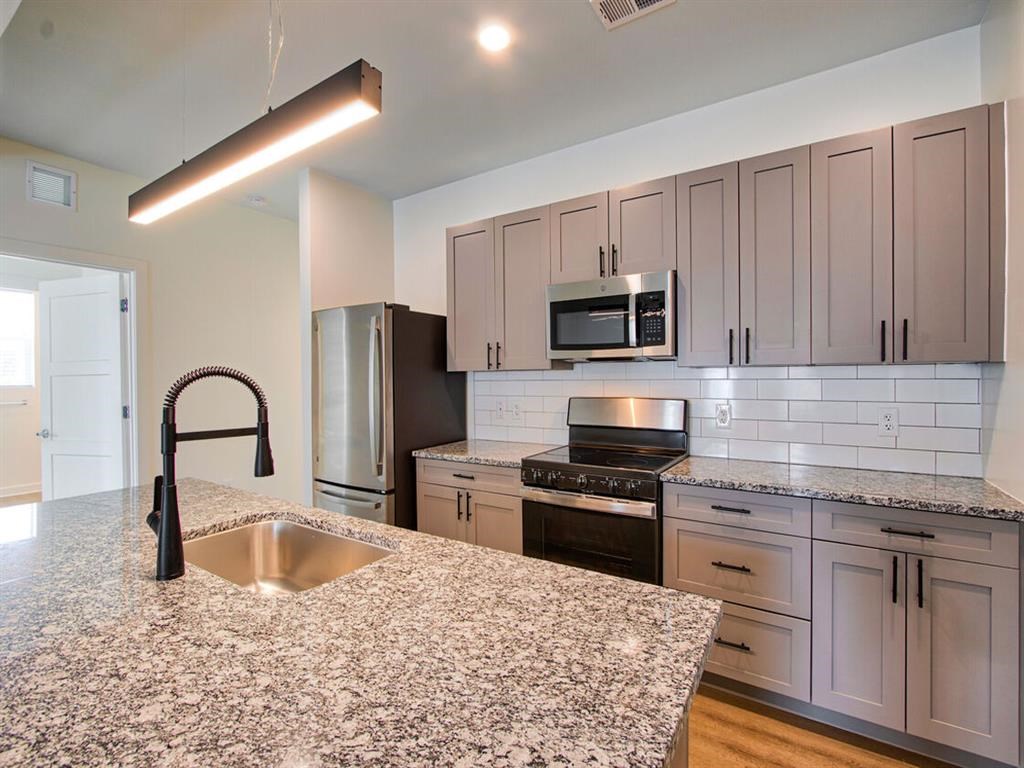 a kitchen with a granite counter top and a sink
