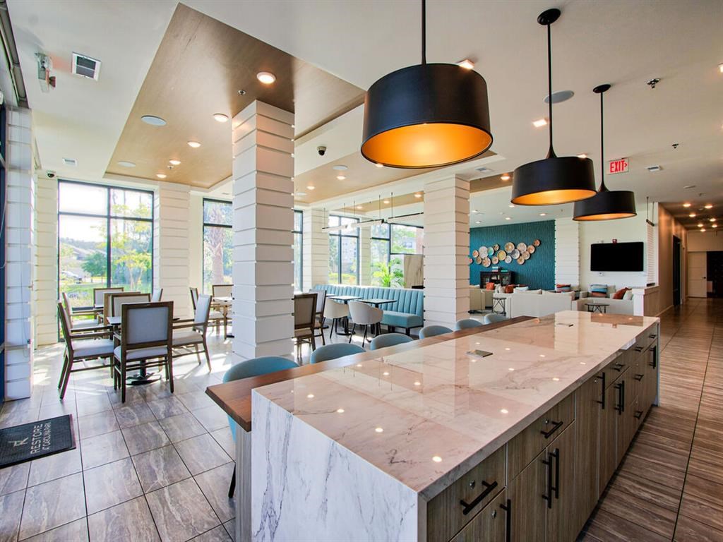 a large counter top in a restaurant with tables and chairs