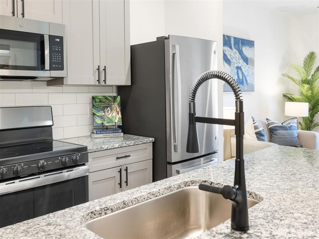 a kitchen with stainless steel appliances and granite counter tops