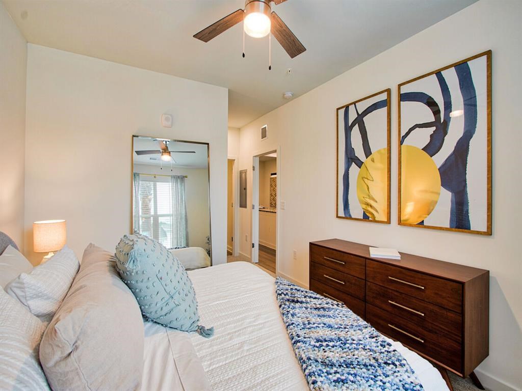 a bedroom with a bed and a ceiling fan