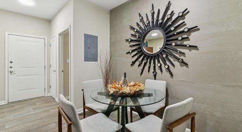 A dining room with a glass table and chairs.