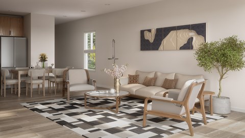 A modern living room with a large sofa, a coffee table, and a painting on the wall.