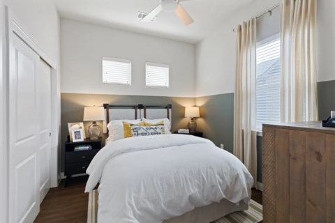 A bedroom with a large bed and a wooden headboard.