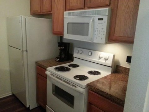A white stove and microwave in a kitchen.