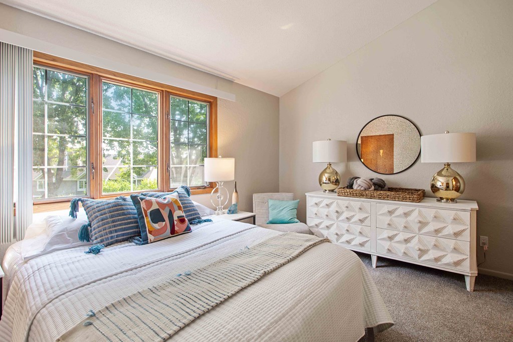 Seasons Villas - Bedroom With a Cozy Bed, Set of Windows, and a Dresser With a Mirror