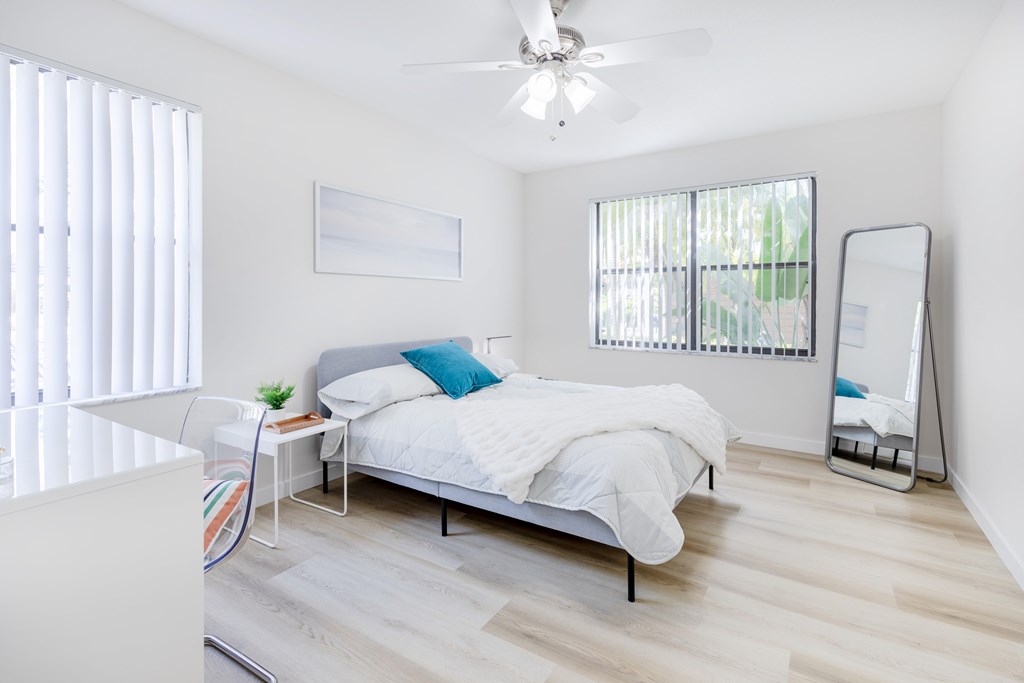 Spacious bedroom with wood flooring