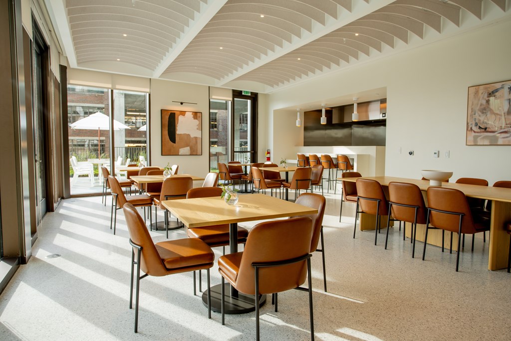 a dining room with tables and chairs and a large window