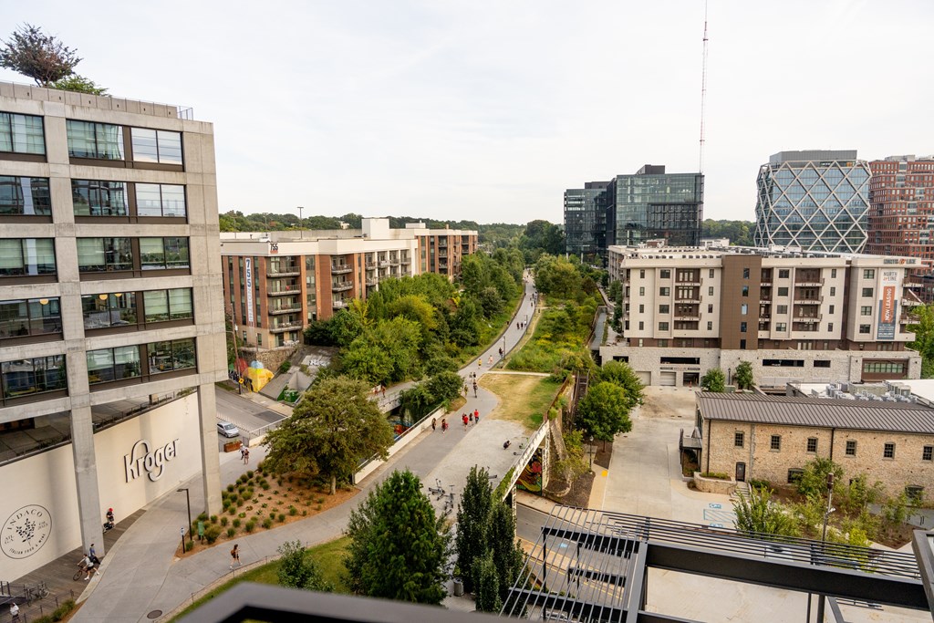 an aerial view of a city street with buildings and trees