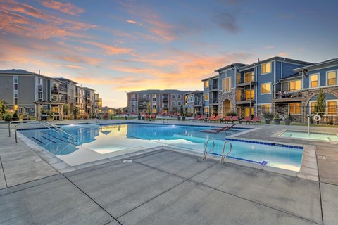A large swimming pool surrounded by apartment buildings.