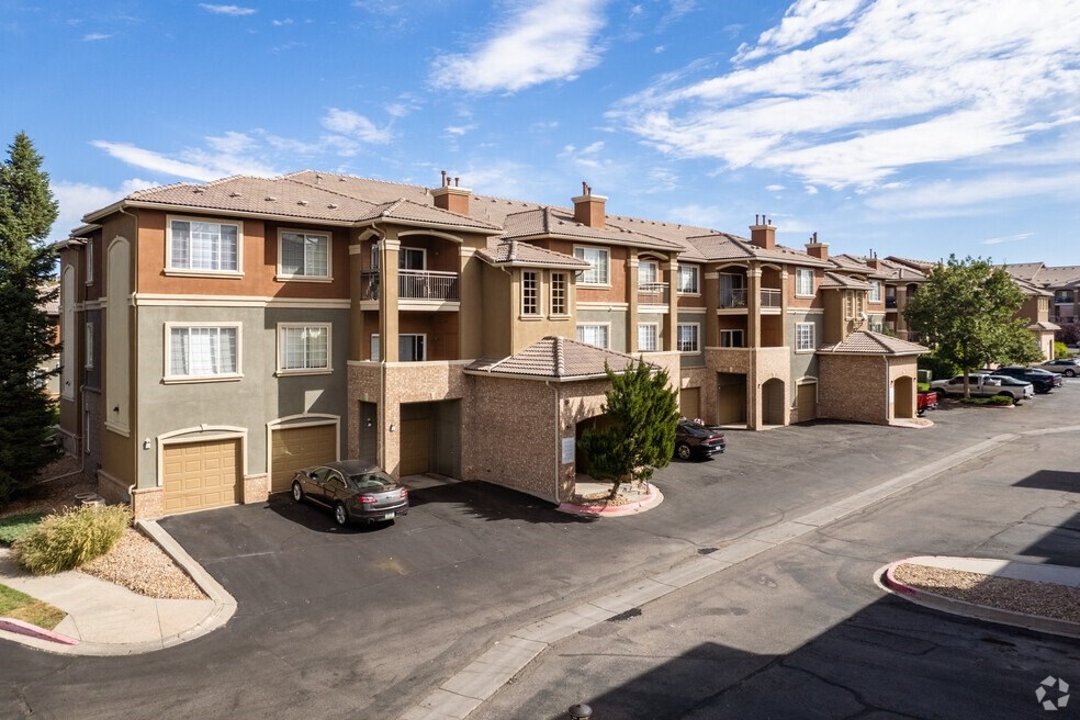 an aerial view of an apartment complex with cars parked in a parking lot