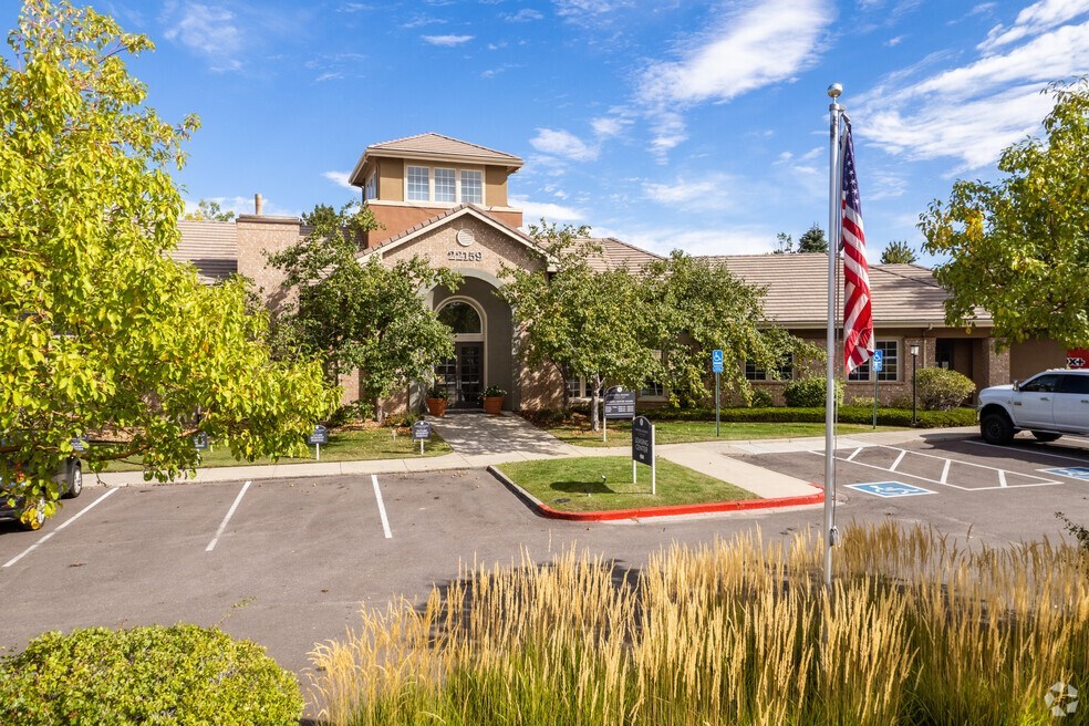 a parking lot with an flag in front of a building