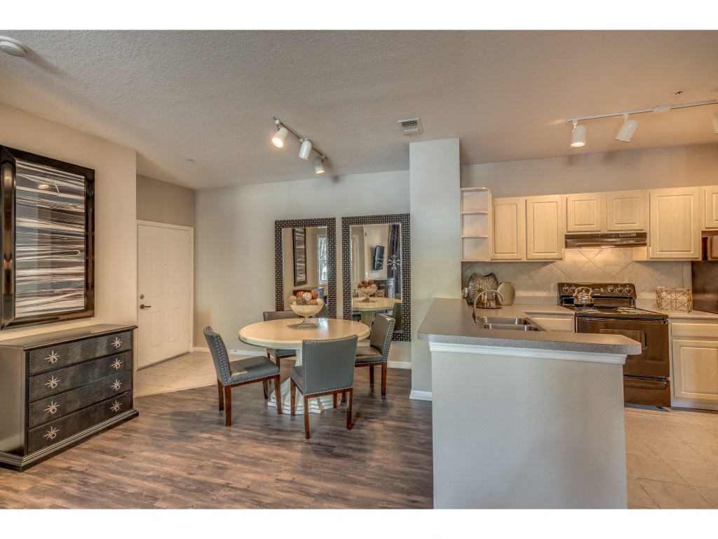 an open kitchen and dining room with a table and chairs