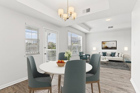 a dining room with a table and chairs and a living room
