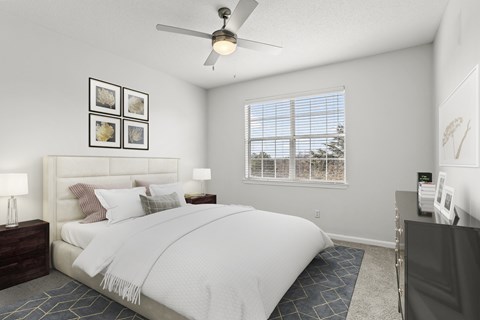 a bedroom with a white bed and a ceiling fan