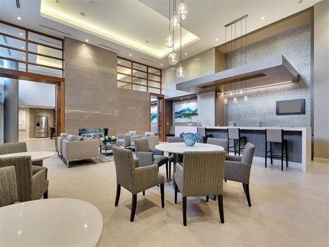 a large living room with tables and chairs and a fireplace