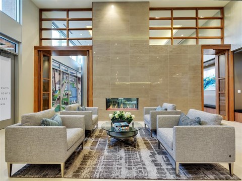a living room with couches and a table and a fireplace