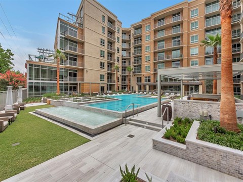 a swimming pool in front of an apartment building