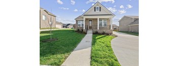 a house with a sidewalk in front of it