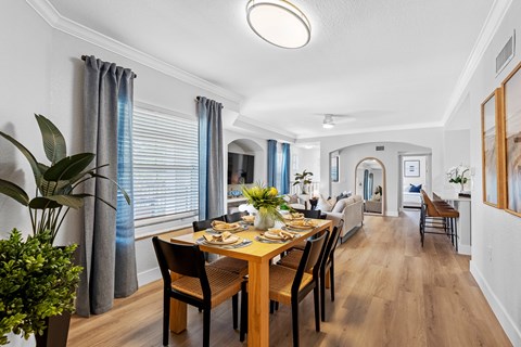 A dining room with a wooden table and chairs.