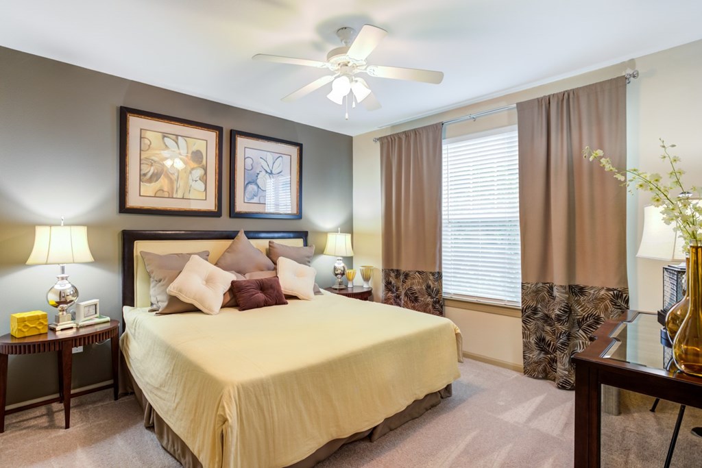 Hendersonville Apartments For Rent - The Grove At Waterford Crossing - Bedroom With Bed, Nightstands, Lamps, Ceiling Fan, And Window.