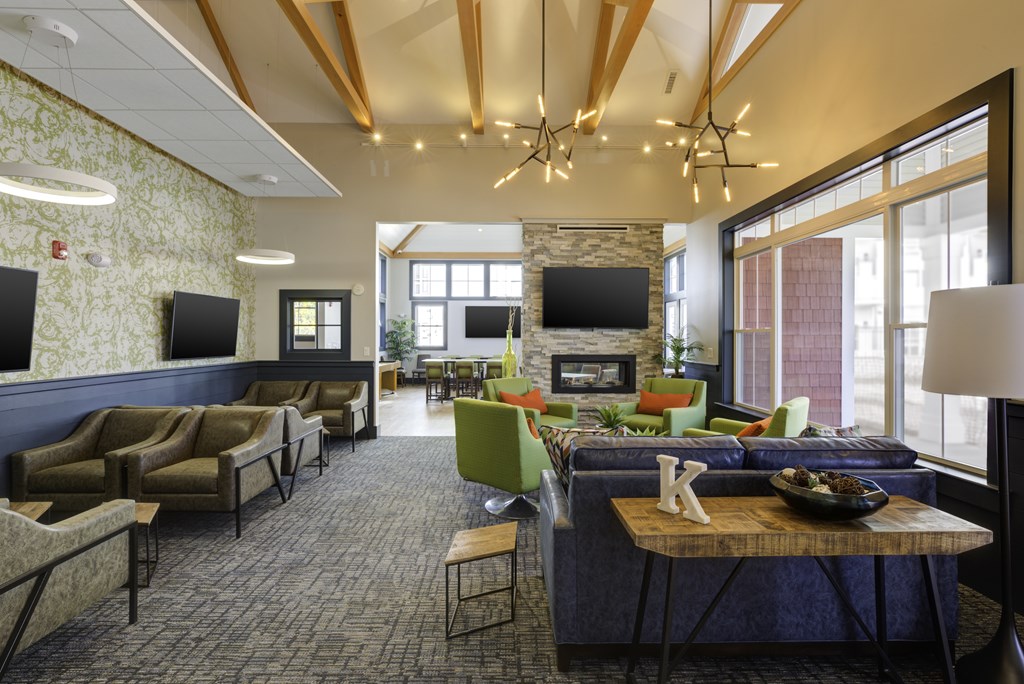 A living room with a stone fireplace and a large couch.