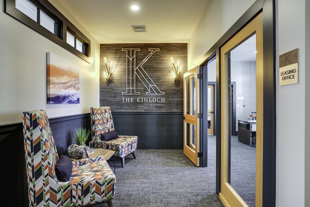 A waiting area with chairs and a sign that says "The Kinouch".