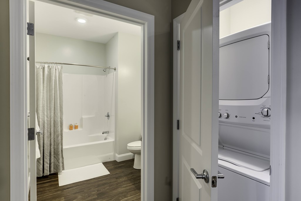 A bathroom with a toilet, a bathtub, and a sink.
