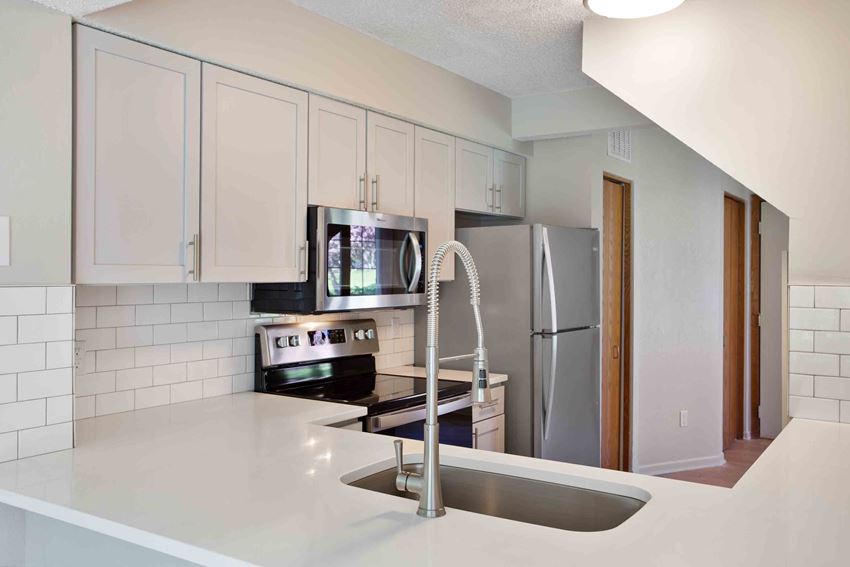Updated kitchen with gray cabinets and stainless steel appliances - Photo Gallery