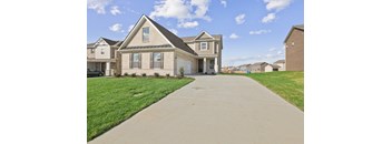 a house with a long sidewalk in front of it