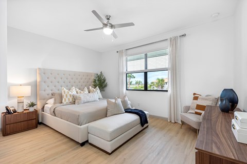 a bedroom with a bed and a ceiling fan