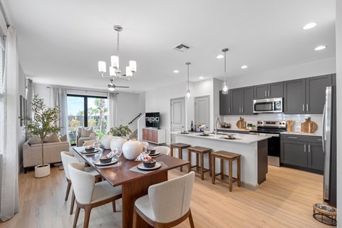 an open kitchen and dining room with a table and chairs