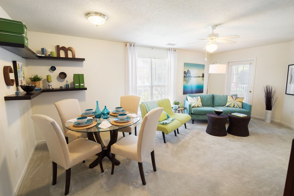 A dining room with a glass table and chairs.