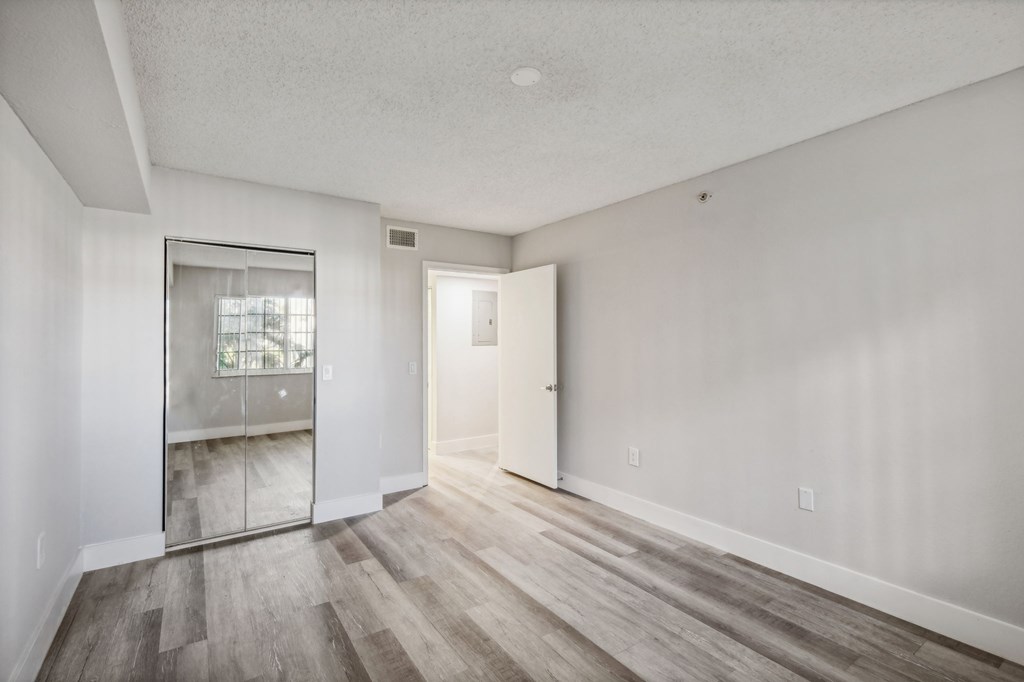 A room with a wooden floor and white walls.