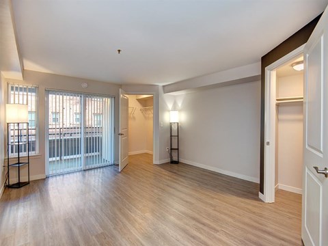 a bedroom with a door leading to a balcony