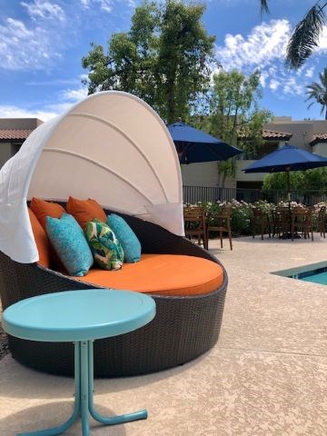 a couch that is sitting next to a pool