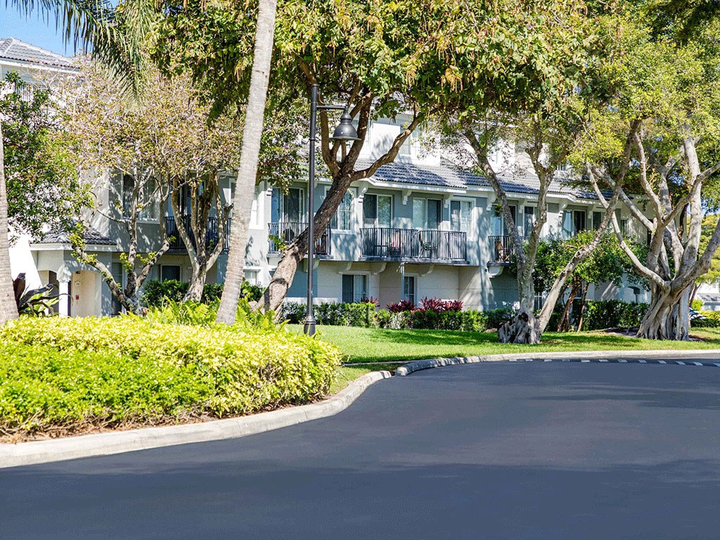 an empty street in front of an apartment building