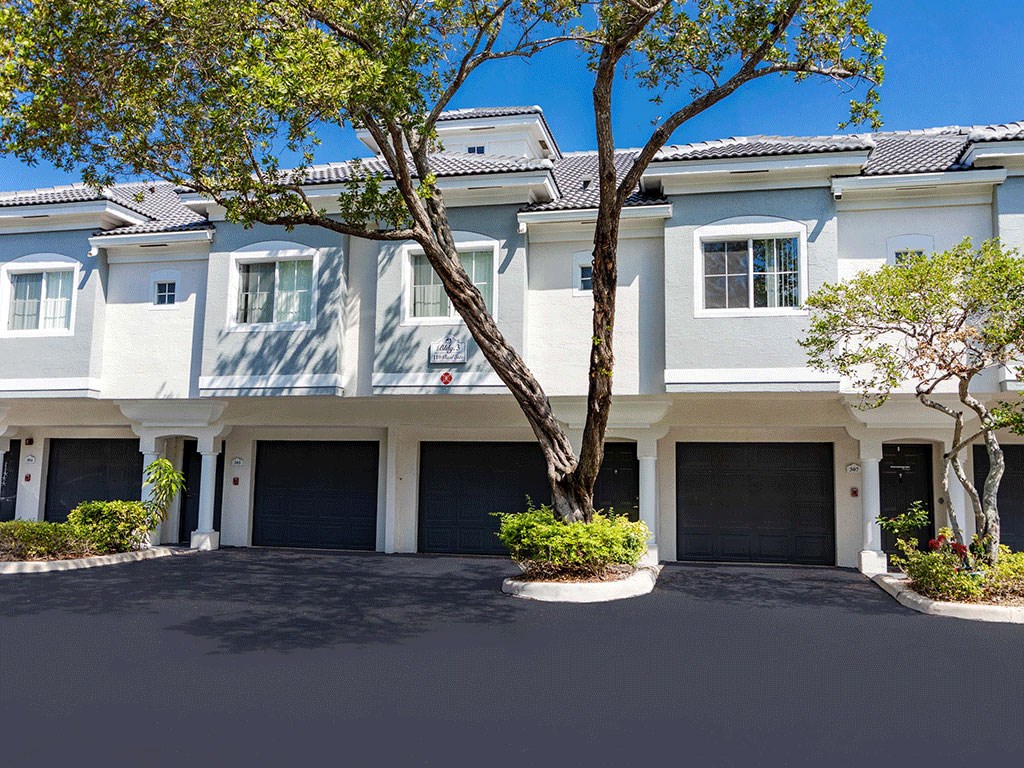a large white house with a tree in front of it